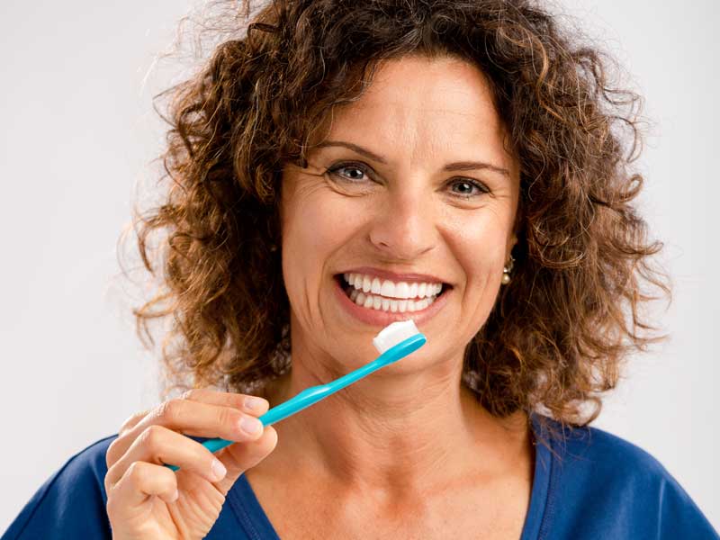 Woman is Brushing Her Teeth