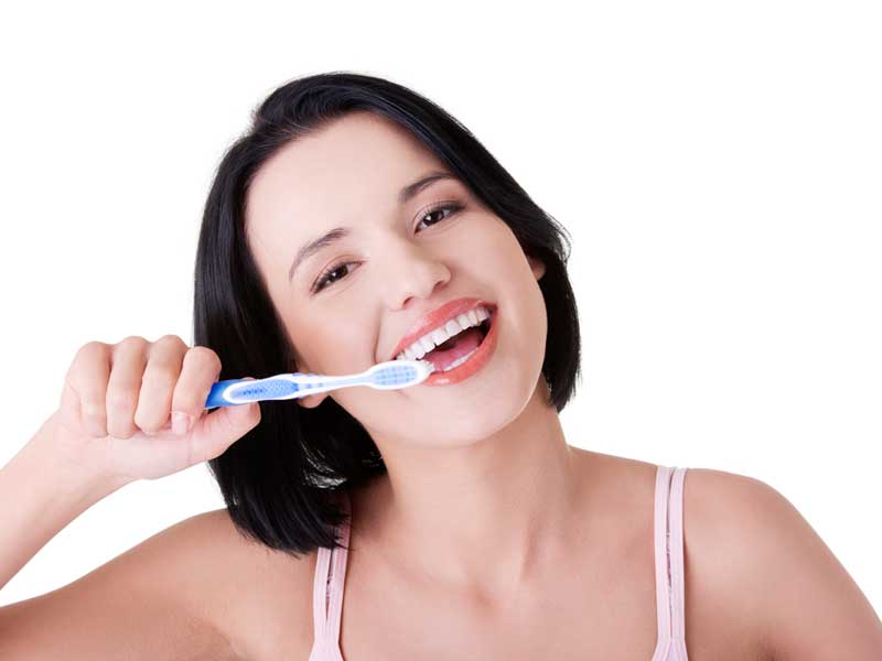 Happy Girl is Brushing Her Teeth