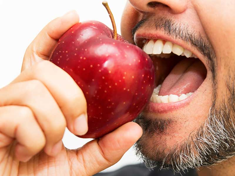 Man is Eating An Apple
