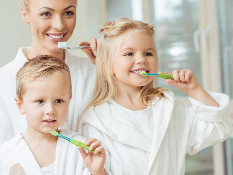 Mother and Kids are Brushing Their Teeth