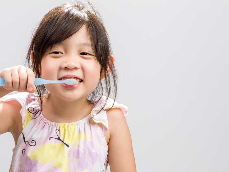 Little Girl is Brushing Her Teeth