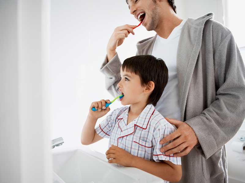 Father and Son are Brushing Their Teeth