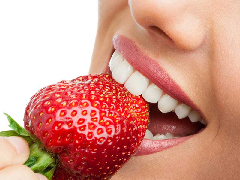 Girl is Eating A Strawberry
